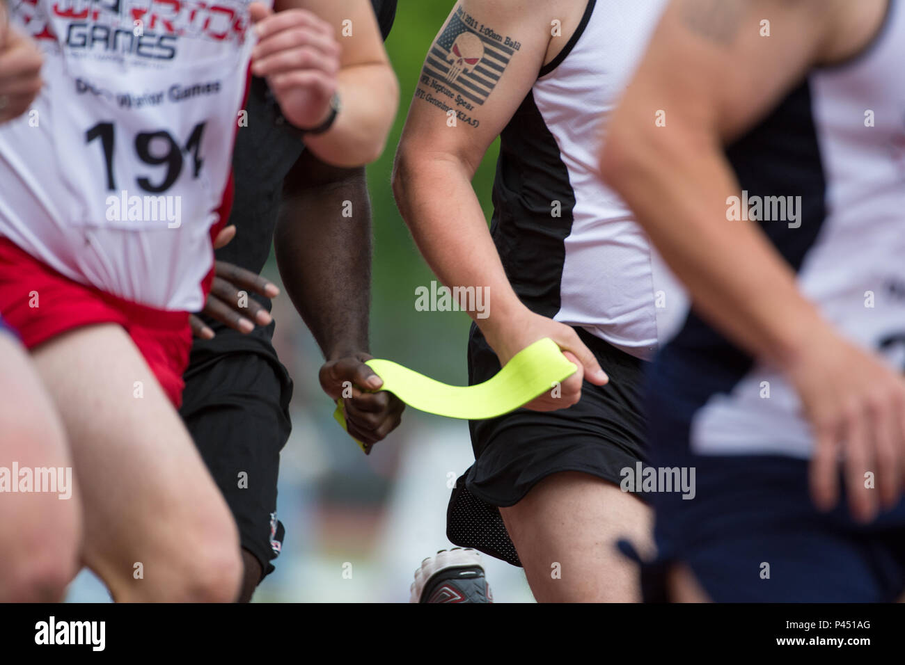 A ribbon tethers a visually impaired runner with his guide during an 800  meter race during the 2016 Department of Defense Warrior Games at the U.S.  Military Academy in West Point, N.Y.