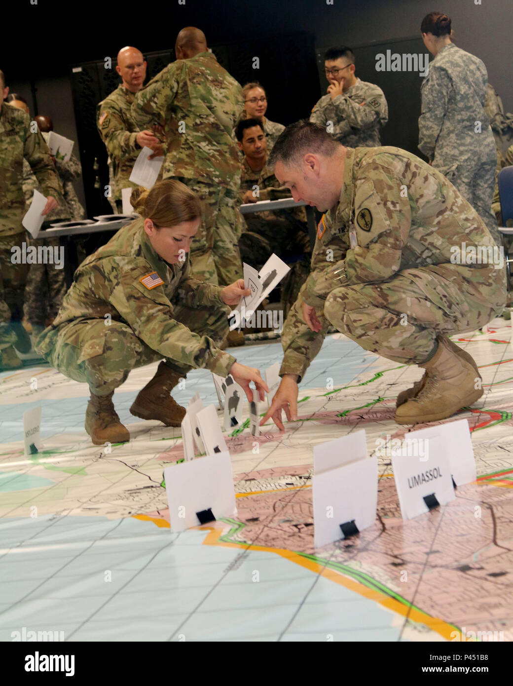 1st Lt. Neriann Velez-Rosado (left), supply officer, 391st Engineer Battalion, and Cpt. Michael Franzen, operations officer, 530th Military Police Battalion, discuss placement of their organizations operational equipment on a simulated training map during exercise Imua Dawn16 rehearsal of concept drill, Sagamihara Depot, Japan, June 14, 2016.  Exercises such as Imua Dawn16 are fundamental training opportunities for military forces in foreign humanitarian assistance to rapidly respond to help mitigate human suffering and greater property damage. Stock Photo