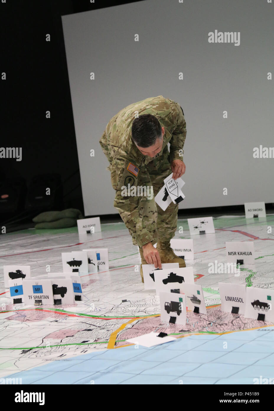 Cpt. Mark Franzen, operations officer, 530th Military Police Battalion, places an image on a simulated training map during exercise Imua Dawn16 rehearsal of concept drill, Sagamihara Depot, Japan, June 14, 2016.  This year’s Imua Dawn 16 exercise focuses on maneuver support operations and enhancing cooperative capabilities in mobility, humanitarian assistance and disaster relief and sustainment support in the event of natural disasters and other crises that threaten public safety and health. Exercises such as Imua Dawn16 are fundamental training opportunities for military forces to refine tech Stock Photo