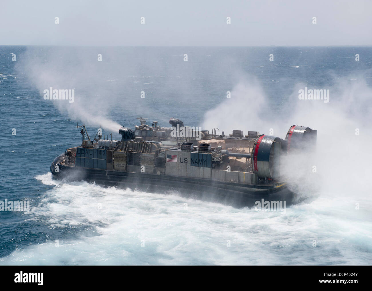 A Landing Craft Air Cushion (LCAC) departs the well deck of amphibious ...