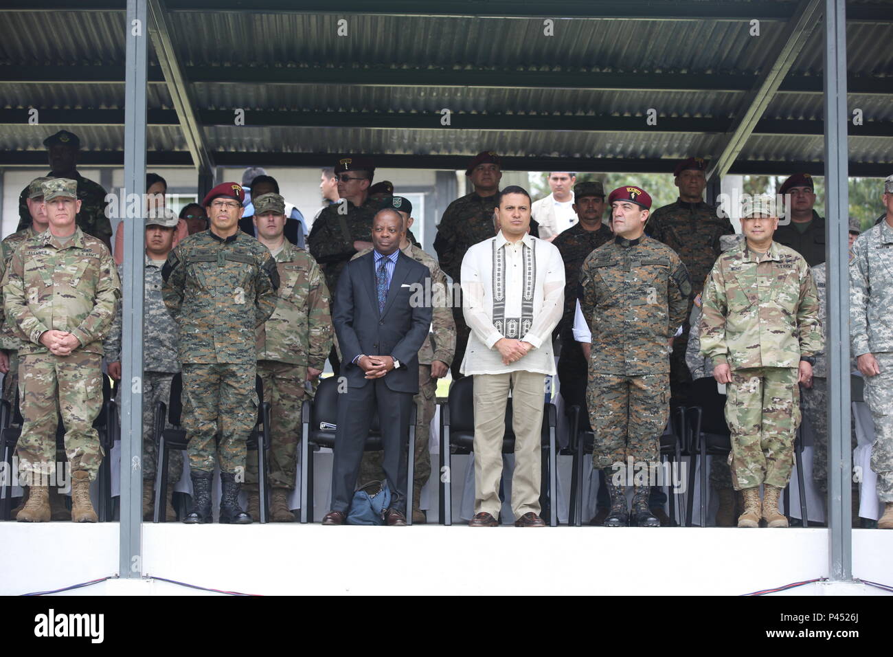 U.S. Army Brigadier Generals Keith Klemmer (far left) and James P. Wong (far right) await the beginning of the ceremony with Todd Robinson Ambassador of Guatemala, Carlos Raul Morales Moscoso, Constitutional President of the Republic and Commanding General of the Army of Guatemala, and Brigadier General Juan Manuel Perez Ramirez and Division General Williams Agberto Mansilla Fernandez in San Marcos, Guatemala on June 9, 2016. Task Force Red Wolf and Army South conducts Humanitarian Civil Assistance Training to include tactical level construction project and Medical Readiness Training Exercises Stock Photo