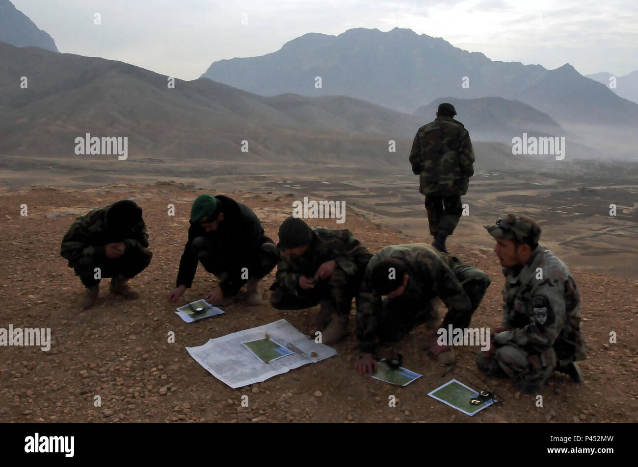 KABUL, Afghanistan – Students from the Afghan National Army Air Corps forward observing class make final calculations before beginning live fire exercises of communicating land targets to HIND MI-35 attack helicopters. These classes will prepare the students to perform these tasks in real combat situations when they will need to draw on air assets to destroy targets in hostile territory. Stock Photo