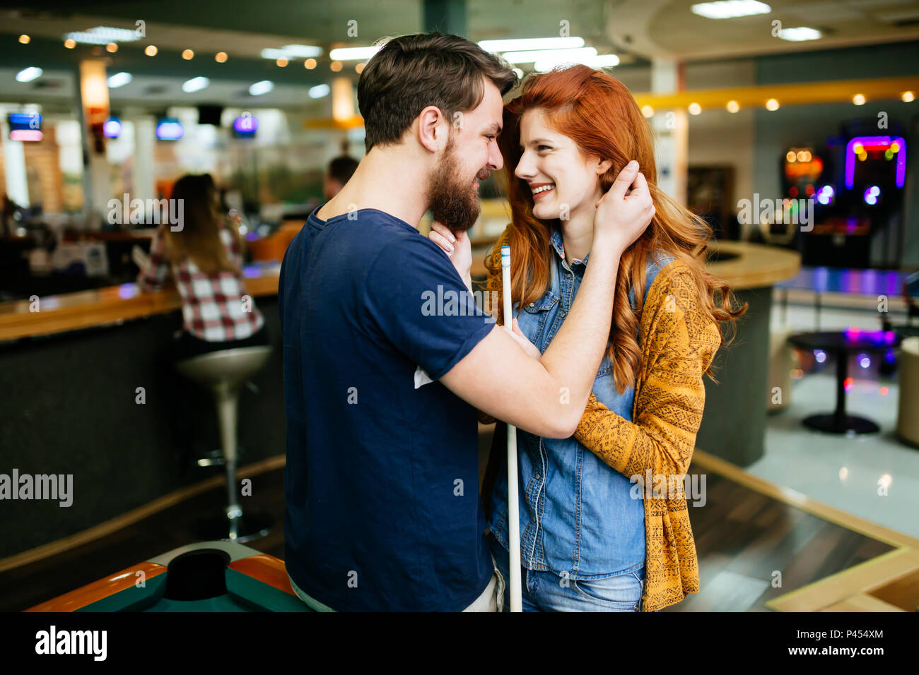 Couple hugging in snooker bar Stock Photo