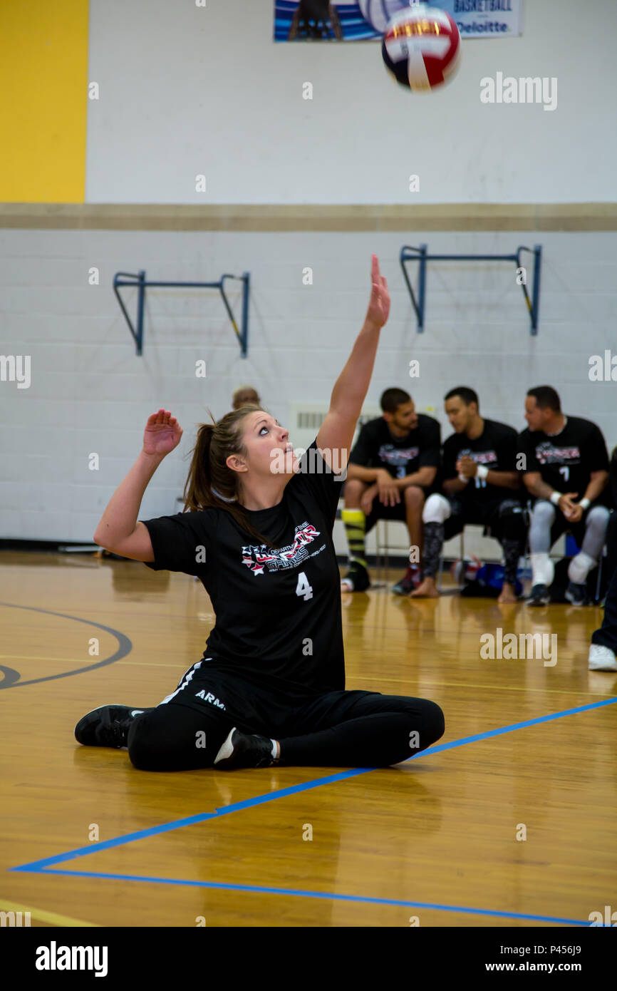 U.S. Army Staff Sgt. Ashley Anderson, of Warrior Transition Battalion, Fort  Riley, Kansas, serves the volleyball for Team Army during the 2016  Department of Defense Warrior Games, in Arvin Gym, at the