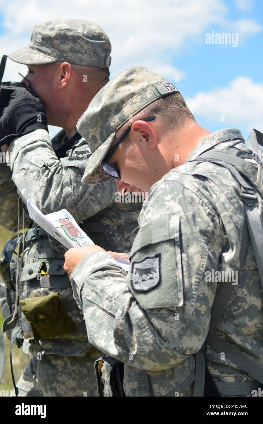 U.S. Army Staff Sgt. Slade Burdine, left, and U.S. Army Sgt. Jason Hodne of  the 109th Regional Support Group locate their coordinates during a land  navigation course in support of the Golden