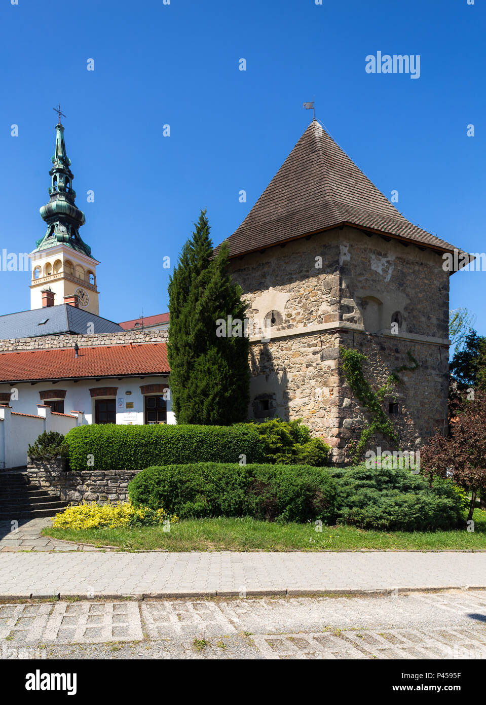 06 May 2018, Novy Jicin, Czech Republic. Old turret and Church of the Assumption of the Virgin Mary Stock Photo