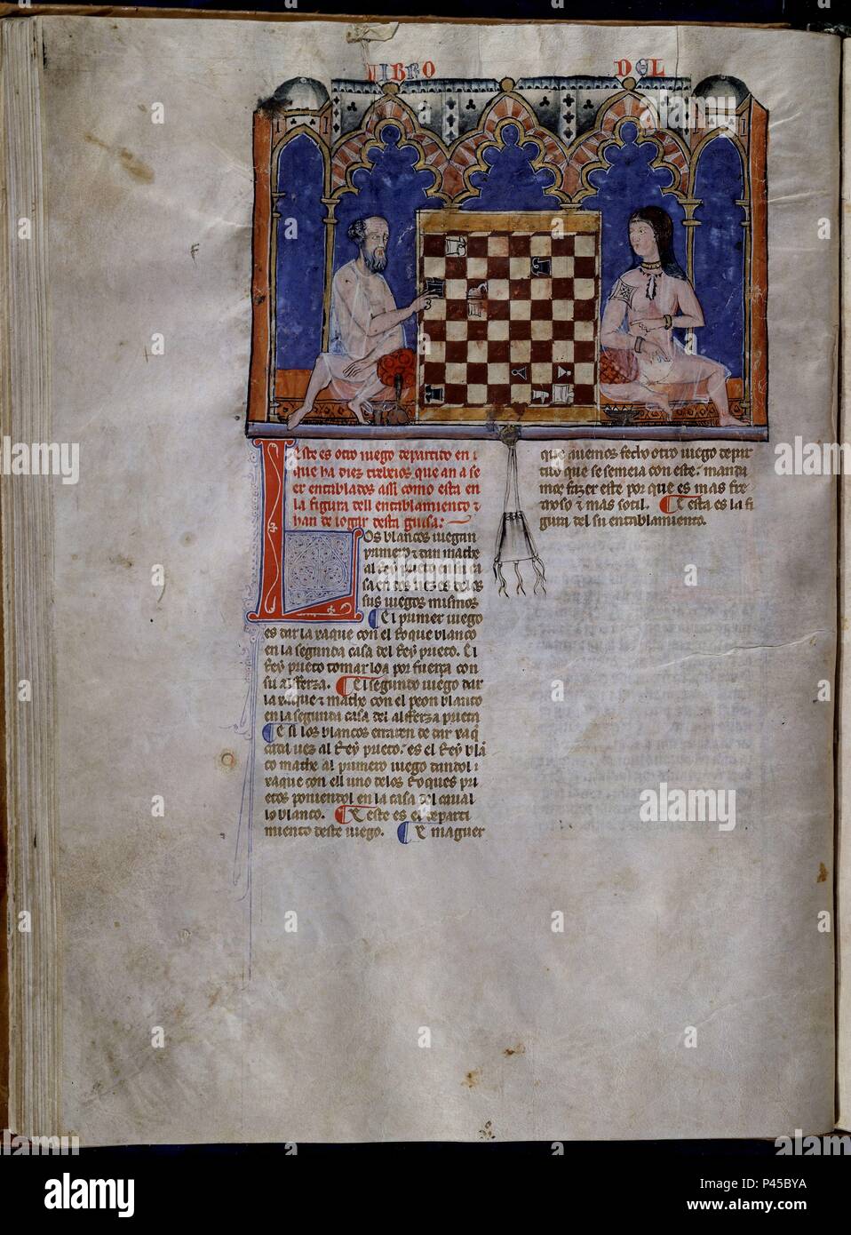 LIBRO DE JUEGOS O LIBRO DEL AJEDREZ DADOS Y TABLAS - 1283 - FOLIO 40V - HOMBRE Y MUJER ARABES JUGANDO AL AJEDREZ - MANUSCRITO GOTICO. Author: Alfonso X of Castile the Wise (1221-1284). Location: MONASTERIO-BIBLIOTECA-COLECCION, SAN LORENZO DEL ESCORIAL, MADRID, SPAIN. Stock Photo