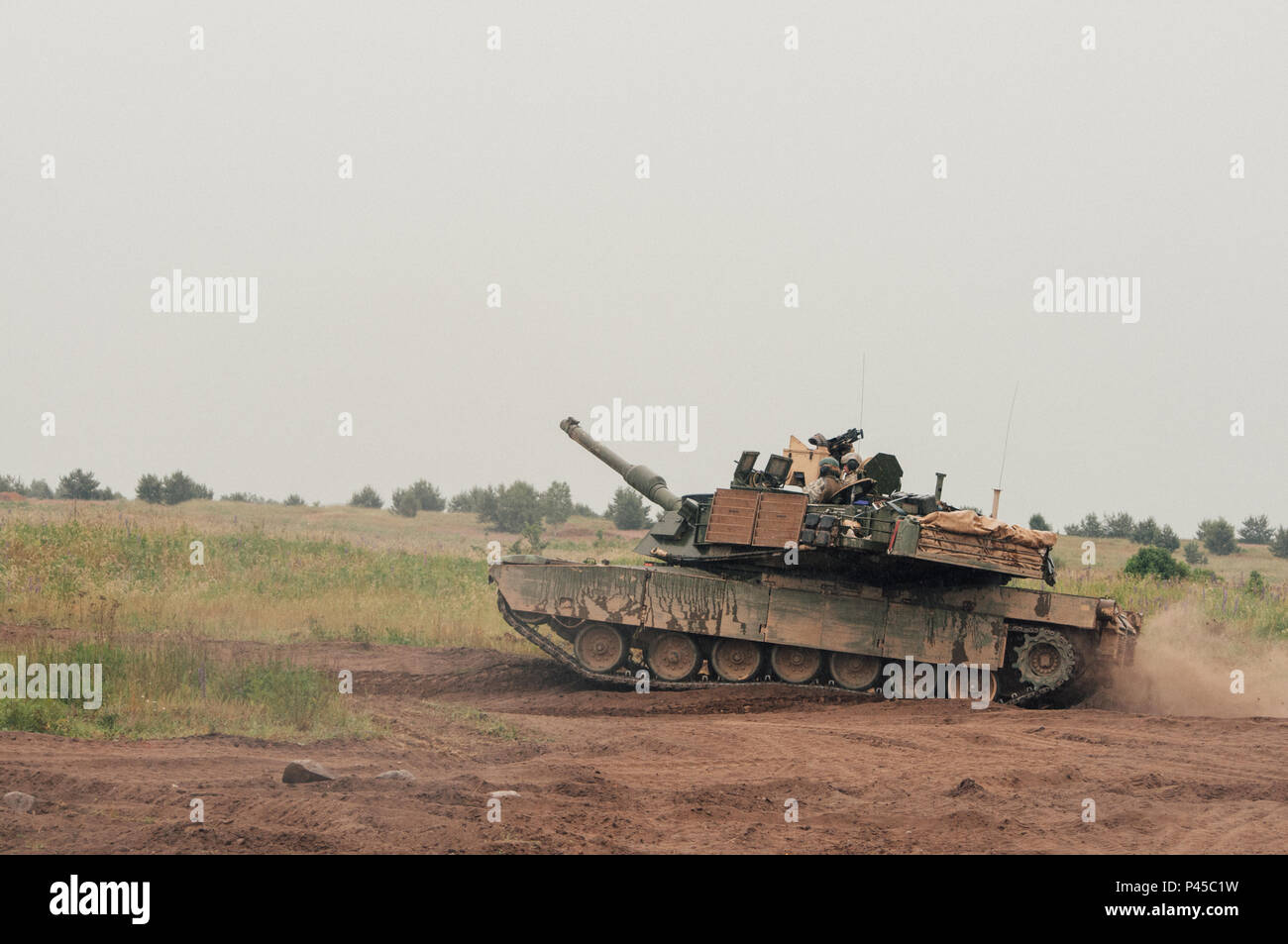 Tank crewman assigned to 3rd Battalion, 69th Armor Regiment, 3rd Infantry Division, maneuver an M1A2 Abrams Main Battle Tank at Drawsko Pomorskie Training Area, Poland Exercise Anakonda 2016, June 13. Exercise Anakonda 16 is a Polish-led, multinational exercise, taking place in Poland from June 7-17. This exercise involves more than 31,000 participants from over nations. Anakonda 16 is a premier training event for U.S. Army Europe, and allied and partner nations. Stock Photo