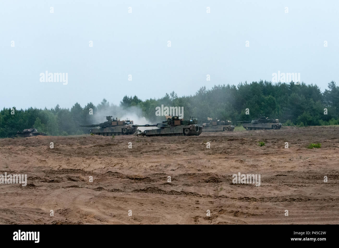 Tank crewman assigned to 3rd Battalion, 69th Armor Regiment, 3rd Infantry Division, maneuver several M1A2 Abrams Main Battle Tank at Drawsko Pomorskie Training Area, Poland Exercise Anakonda 2016, June 13. Exercise Anakonda 16 is a Polish-led, multinational exercise taking place in Poland from June 7-17. This exercise involves more than 31,000 participants from over nations. Anakonda 16 is a premier training event for U.S. Army Europe, and Allied and partner nations. Stock Photo