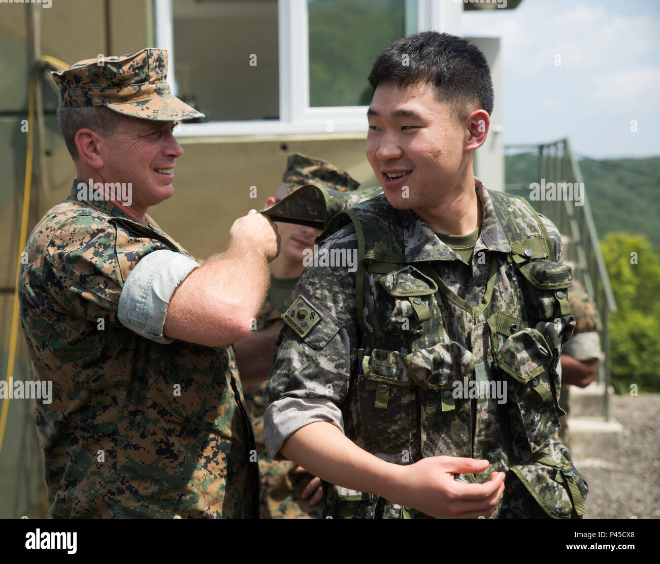Lt. Col. Elvino M. Mendonca Jr. examines Sgt. Jang Lee’s flak jacket June 30, 2016, at Suseong Range, South Korea during a Korean Marine Exchange Program, or KMEP. The goal of the KMEP is to sustain the combined force and enhance the ROK-U.S. team at the tactical level to build combined warfighting capabilities. The U.S. Marines are with Fox Company, 2nd Battalion, 2nd Marine Regiment, currently attached to 4th Marine Regiment, III Marine Expeditionary Force through the unit deployment program The ROK Marines were a part of 73rd Battalion, 7th Regiment, 1st Marine Division. Mendonca, a Lowell, Stock Photo