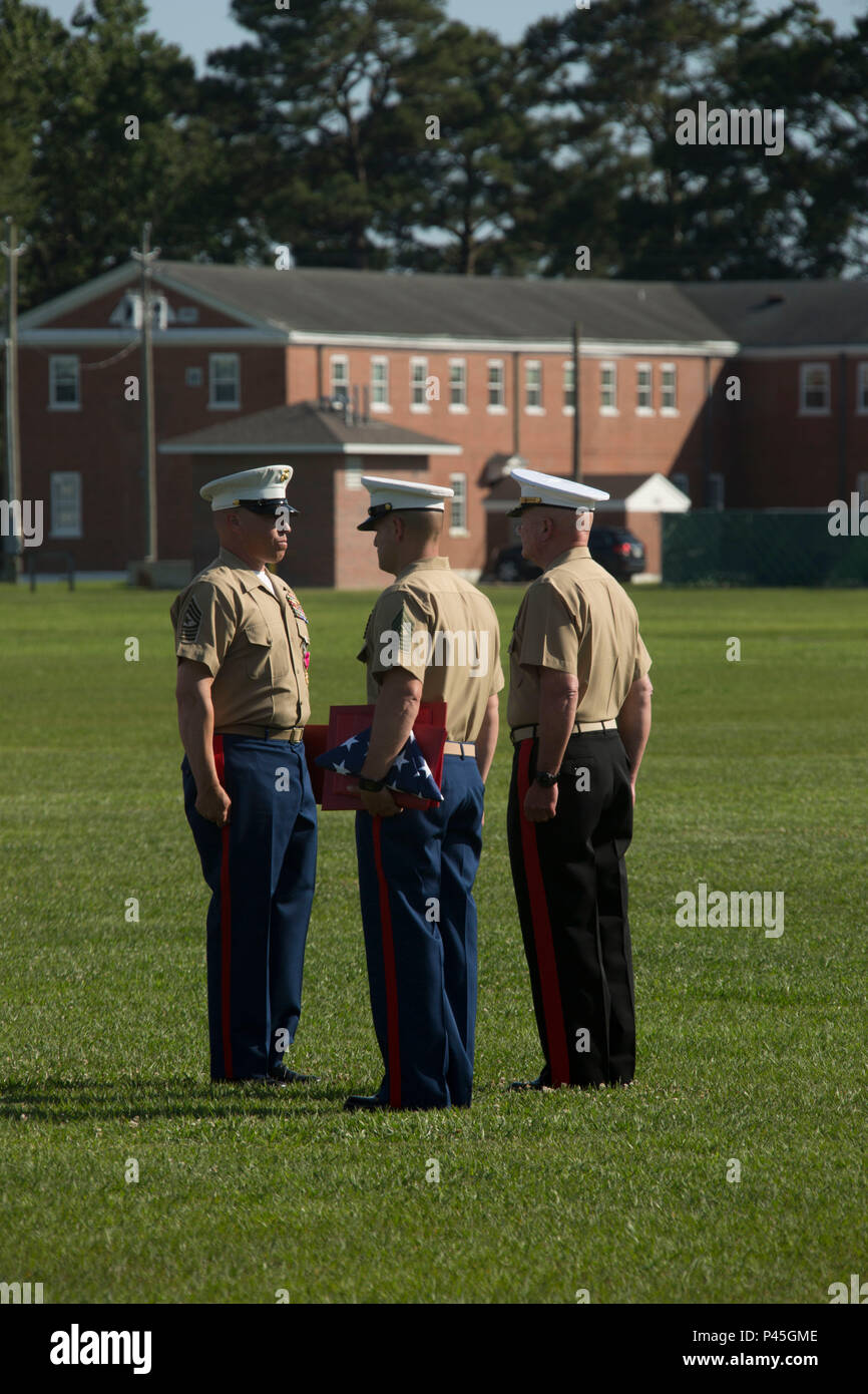 U.S. Marine Corps Maj. Gen. Walter L. Miller Jr. (right), commanding general, II Marine Expeditionary Force, presents Sgt. Maj. Paul A. Berry (left), off going sergeant major, Marine Corps Installations East (MCIEAST), Marine Corps Base Camp Lejeune (MCB CAMLEJ), with awards during a retirement ceremony for MCIEAST, MCB CAMLEJ, on William Pendleton Thompson Hill Field, Camp Lejeune, June 9, 2016. Berry retired after 30 years of honorable and faithful service. (U.S. Marine Corps photo by Lance Cpl. Careaf L. Henson, MCIEAST Combat Camera/Released) Stock Photo