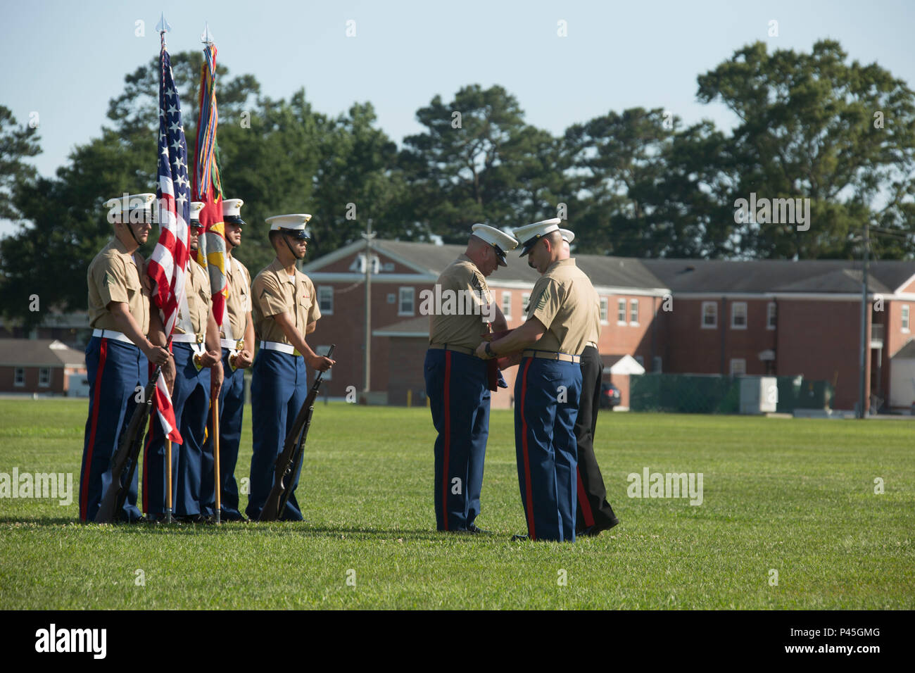 U.S. Marine Corps Maj. Gen. Walter L. Miller Jr. (right), commanding general, II Marine Expeditionary Force, presents Sgt. Maj. Paul A. Berry (left), off going sergeant major, Marine Corps Installations East (MCIEAST), Marine Corps Base Camp Lejeune (MCB CAMLEJ), with awards during a retirement ceremony for MCIEAST, MCB CAMLEJ, on William Pendleton Thompson Hill Field, Camp Lejeune, June 9, 2016. Berry retired after 30 years of honorable and faithful service. (U.S. Marine Corps photo by Lance Cpl. Careaf L. Henson, MCIEAST Combat Camera/Released) Stock Photo