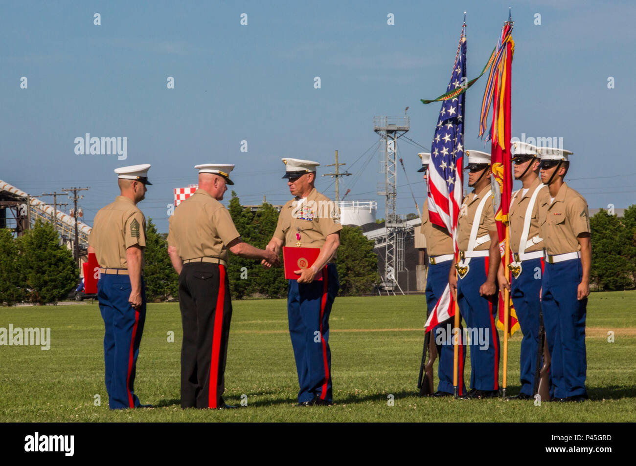 U.S. Marine Corps Maj. Gen. Walter L. Miller Jr. (center), commanding general, II Marine Expeditionary Force, congratulates Sgt. Maj. Paul A. Berry, during his retirement, on William Pendleton Thomas Hill Field, June 9, 2016. Berry retired after 30 years of honorable and faithful service. (U.S. Marine Corps photo by Lance Cpl. Judith L. Harter, MCIEAST Combat Camera/Released) Stock Photo