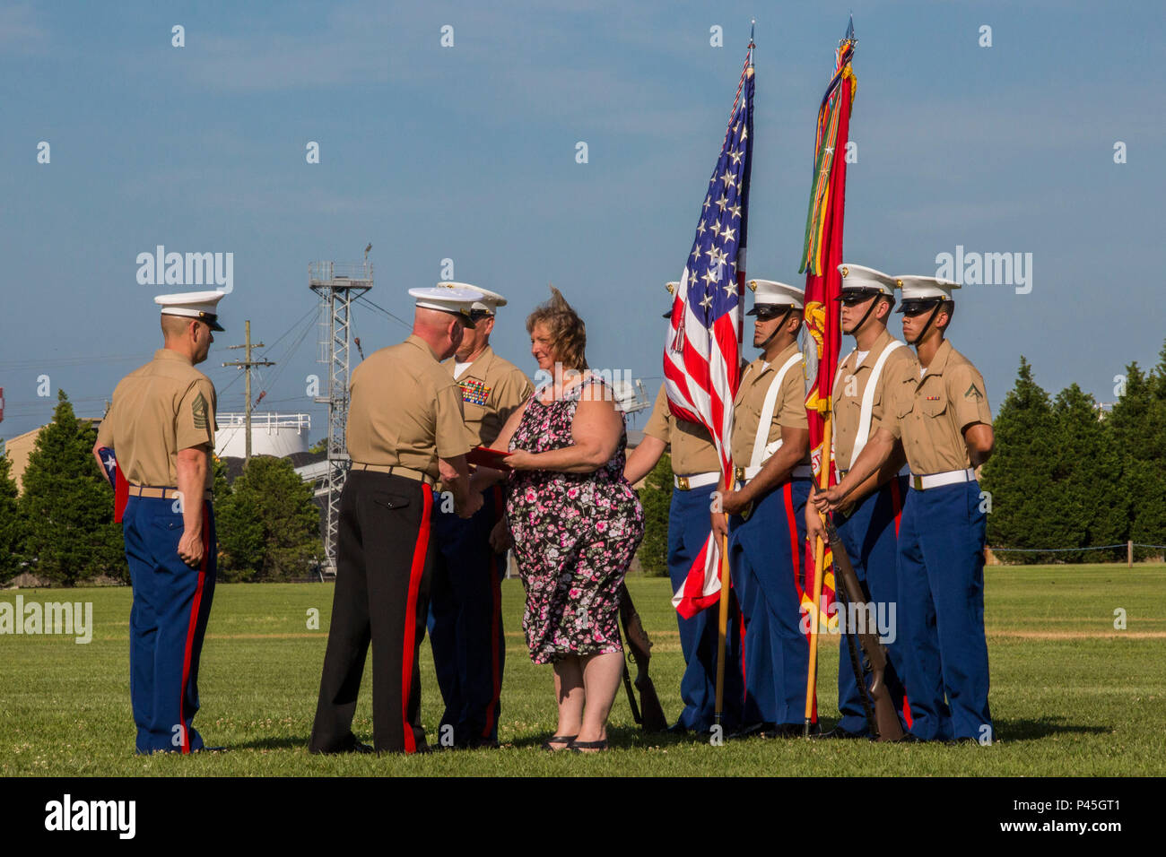 U.S. Marine Corps Maj. Gen. Walter L. Miller Jr. (center), commanding general, II Marine Expeditionary Force, presents Mrs. Mary Berry, wife of Sgt. Maj. Paul A. Berry, with an award during her husband’s retirement ceremony, on William Pendleton Thomas Hill Field, June 9, 2016. Berry retired after 30 years of honorable and faithful service. (U.S. Marine Corps photo by Lance Cpl. Judith L. Harter, MCIEAST Combat Camera/Released) Stock Photo