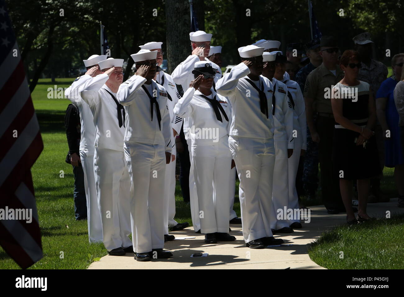 U.S. Navy sailors render salutes during a funeral for World War II