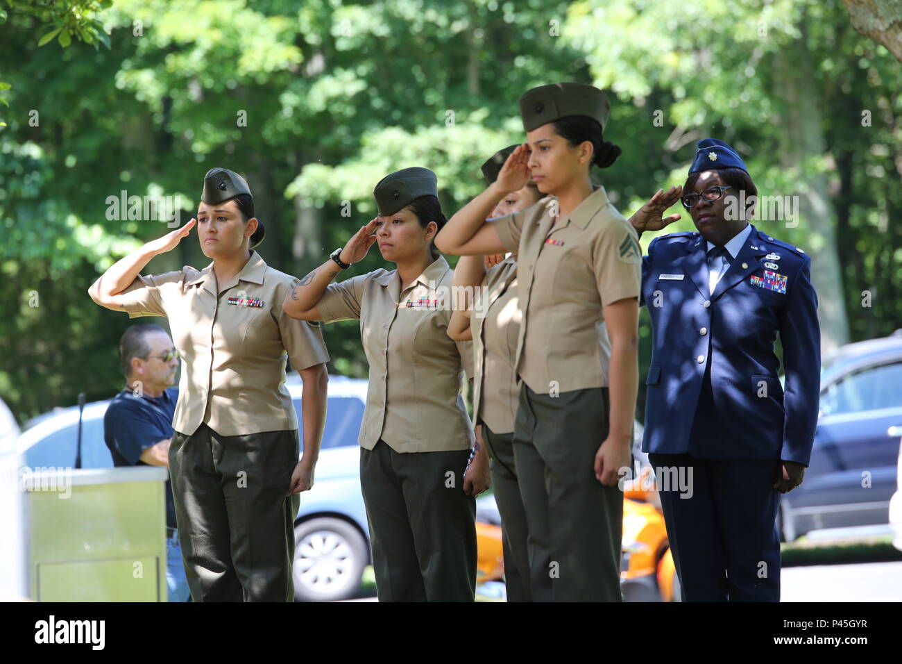 U.S. Marines and an Airman render salutes during a funeral for World
