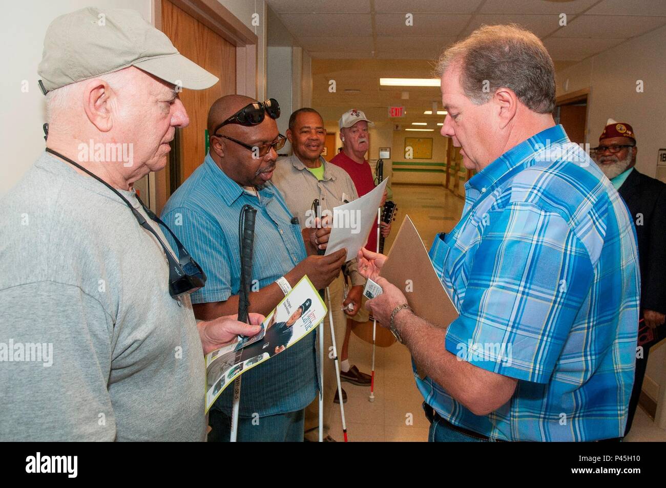 Major league Umpire Jerry Layne visits with veterans and employees of