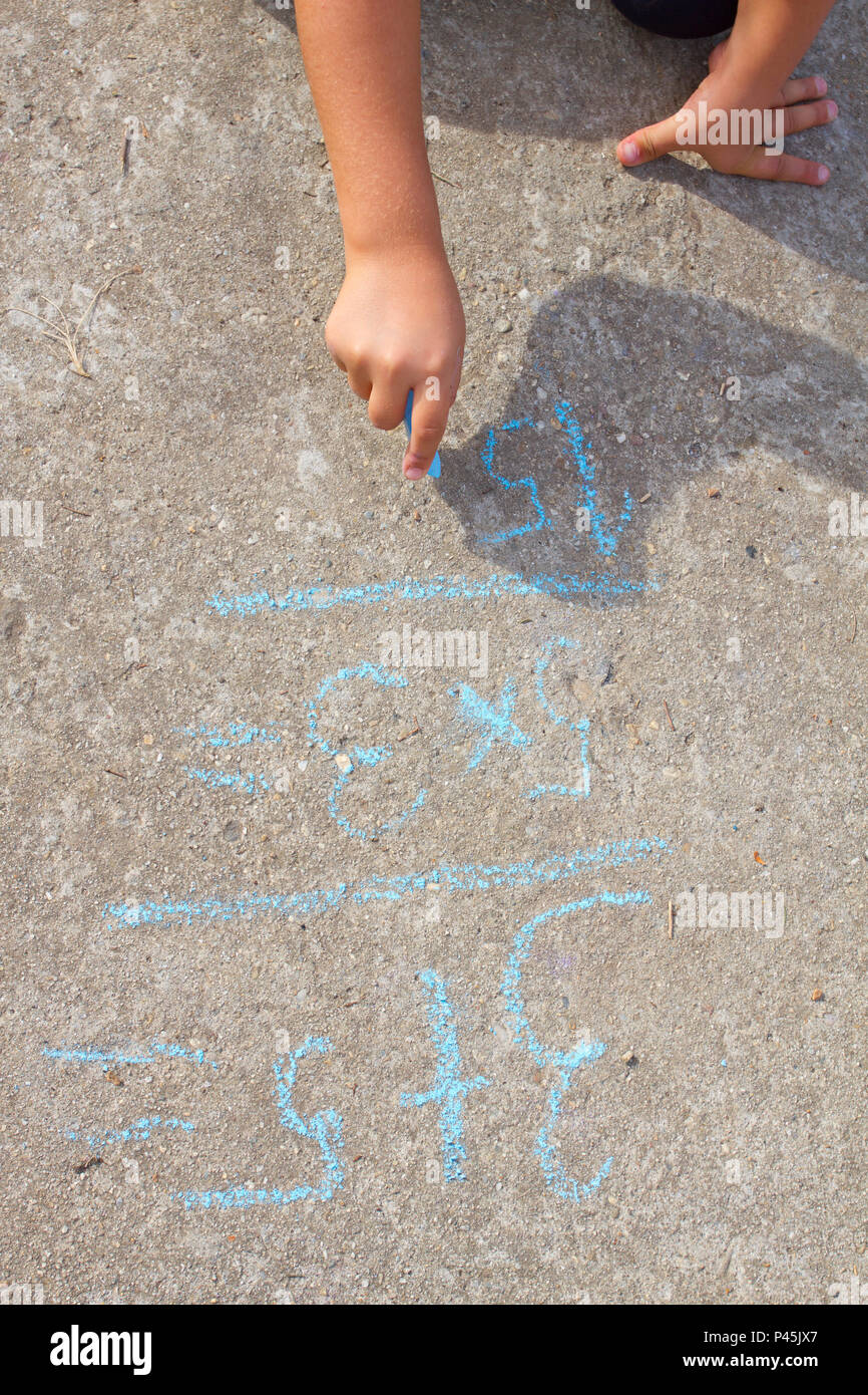 Girl kid thinking, writing and counting on mathematical equations with ...