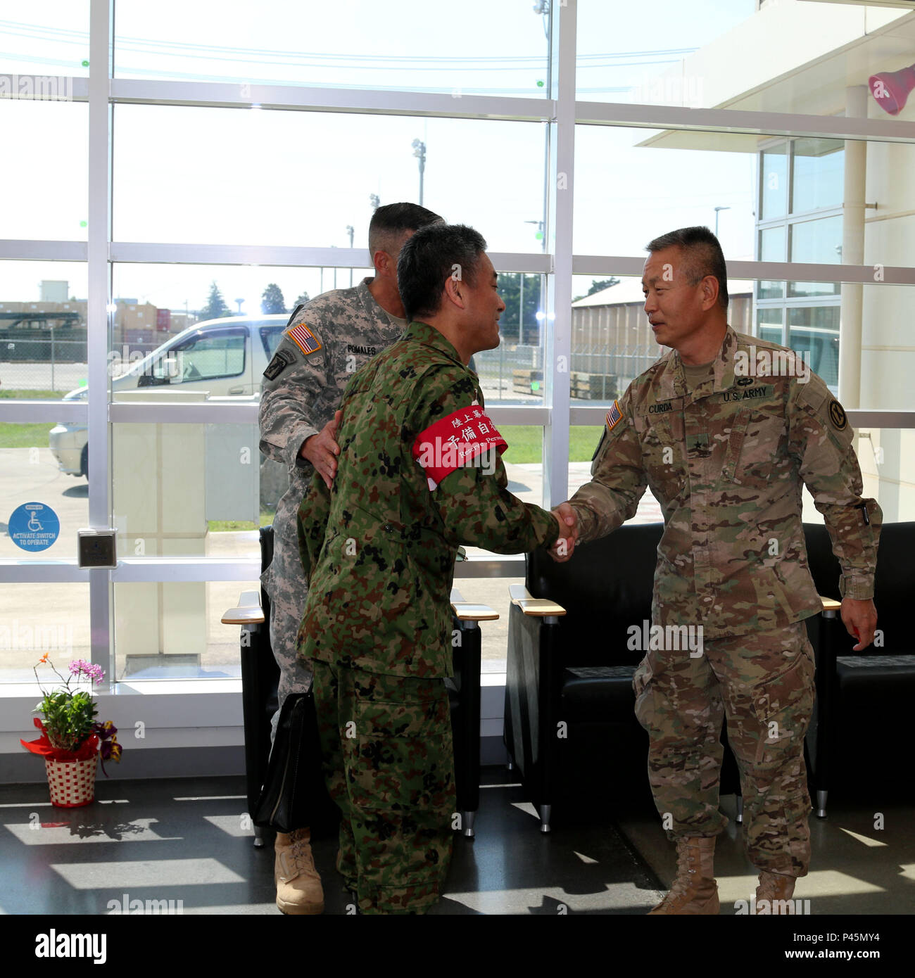 Brig. Gen. Stephen K. Curda, Commander, 9th Mission Support Command, meets with Col. Kei Hasegawa and Col. Luis Pomales, director, Army Reserve Engagement Team-Japan, at Sagamihara Depot Mission Training Complex during exercise Imua Dawn 2016, Sagamihara, Japan, June 18, 2016.  Imua Dawn 2016 provides opportunities for U.S. and Japanese forces to come together and train for potential real world events, better preparing them in supporting regional populations in all Humanitarian Assistance and Disaster Relief (HADR) and Noncombatant Evacuation Operations (NEO). Training together, the U.S. and J Stock Photo