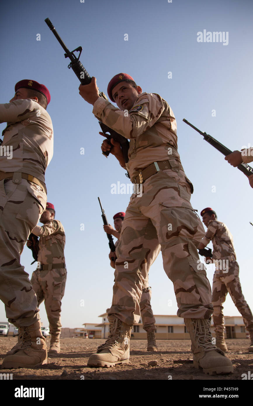 Iraqi soldiers practice bayonette movements with their weapons under the supervision of New Zealand coalition partners during a junior leadership course at Camp Taji, Iraq, June 22, 2016. Task Group Taji conducted this training to supplement Iraqi soldiers overall tactical capabilities. Training at building partner capacity sites is an integral part of Combined Joint Task Force – Operation Inherent Resolve’s multinational effort to train Iraqi security forces personnel to defeat the Islamic State of Iraq and the Levant. (U.S. Army photo by Spc. Jessica Hurst/Released) Stock Photo