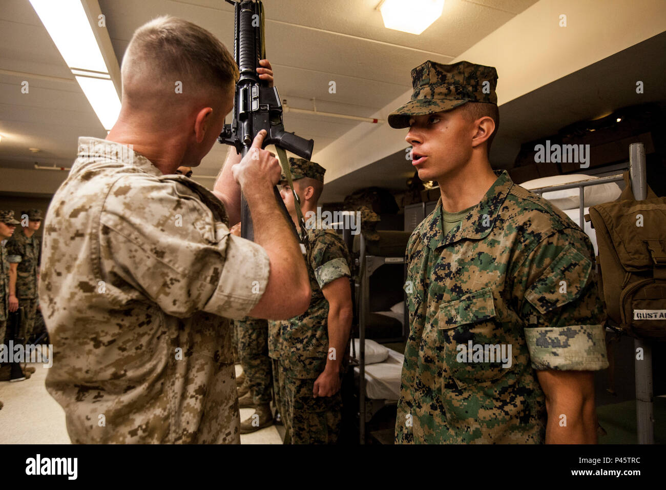 Candidates with Lima Company, Officer Candidate School (OCS) get inspected during the Platoon Commander's Inspection aboard Marine Corps Base Quantico, Va., June 18, 2016. The mission of OCS is to educate and train officer candidates in order to evaluate and screen individuals for qualities required for commissioning as a Marine Corps officer. (U.S. Marine Corps Combat Camera photo by Lance Cpl. Jose Villalobosrocha/Released) Stock Photo