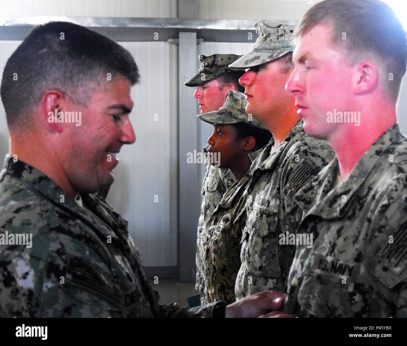 Constructionman Electrician Third Class Jacob Miller receives a