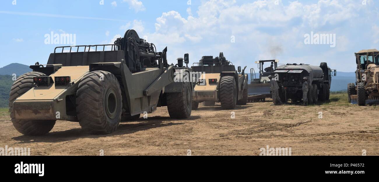 Soldiers with the Forward Support Company, 223rd Engineer Battalion, 168th Engineer Brigade, Mississippi Army National Guard work together to refuel heavy construction equipment on June 12, 2016 during Operation Resolute Castle at Novo Selo Training Area, Bulgaria.  The Forward Support Company works hard to maintain dozens of vehicles being used on multiple construction sites each day.  During Resolute Castle, Engineer Brigades from both the Mississippi and Tennessee Army National Guard are teaming up to improve military infrastructure in Bulgaria as part of United States Army Europe’s efforts Stock Photo