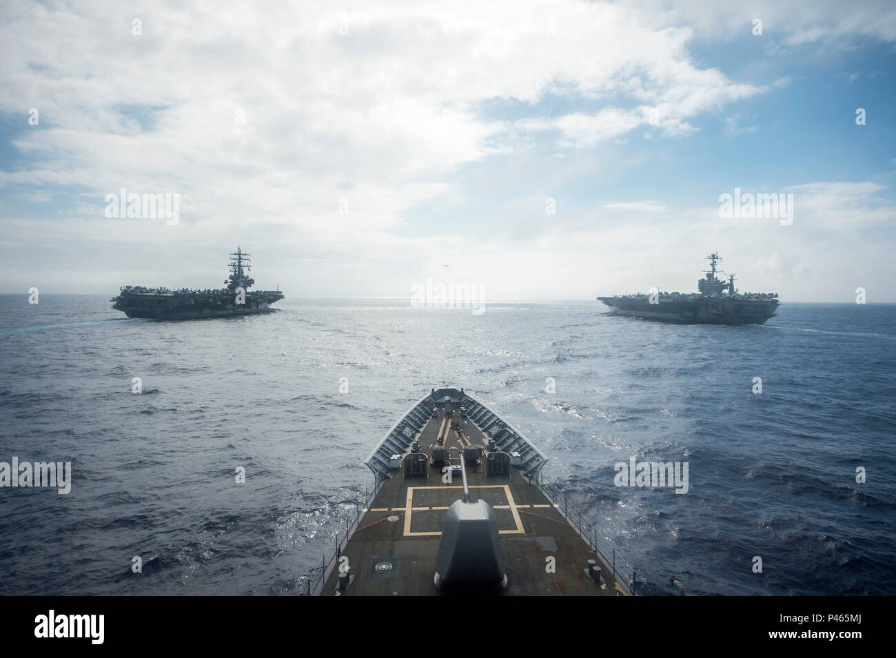 160618-N-UN259-277 WATERS EAST OF JAPAN (June 18, 2016) The Ticonderoga class guided-missile cruiser USS Shiloh (CG 67), steams in formation with the Nimitz-class aircraft carriers USS Ronald Reagan (CVN 76) USS John C. Stennis (CVN 74). Shiloh is on patrol supporting the Ronald Reagan Carrier Strike Group. The Nimitz-class aircraft carriers USS John C. Stennis (CVN 74) and USS Ronald Reagan (CVN 76) conduct dual aircraft carrier strike group operations in the U.S. 7th Fleet area of responsibility supporting security and stability in the Indo-Asia Pacific region.  The operations mark the U.S.  Stock Photo