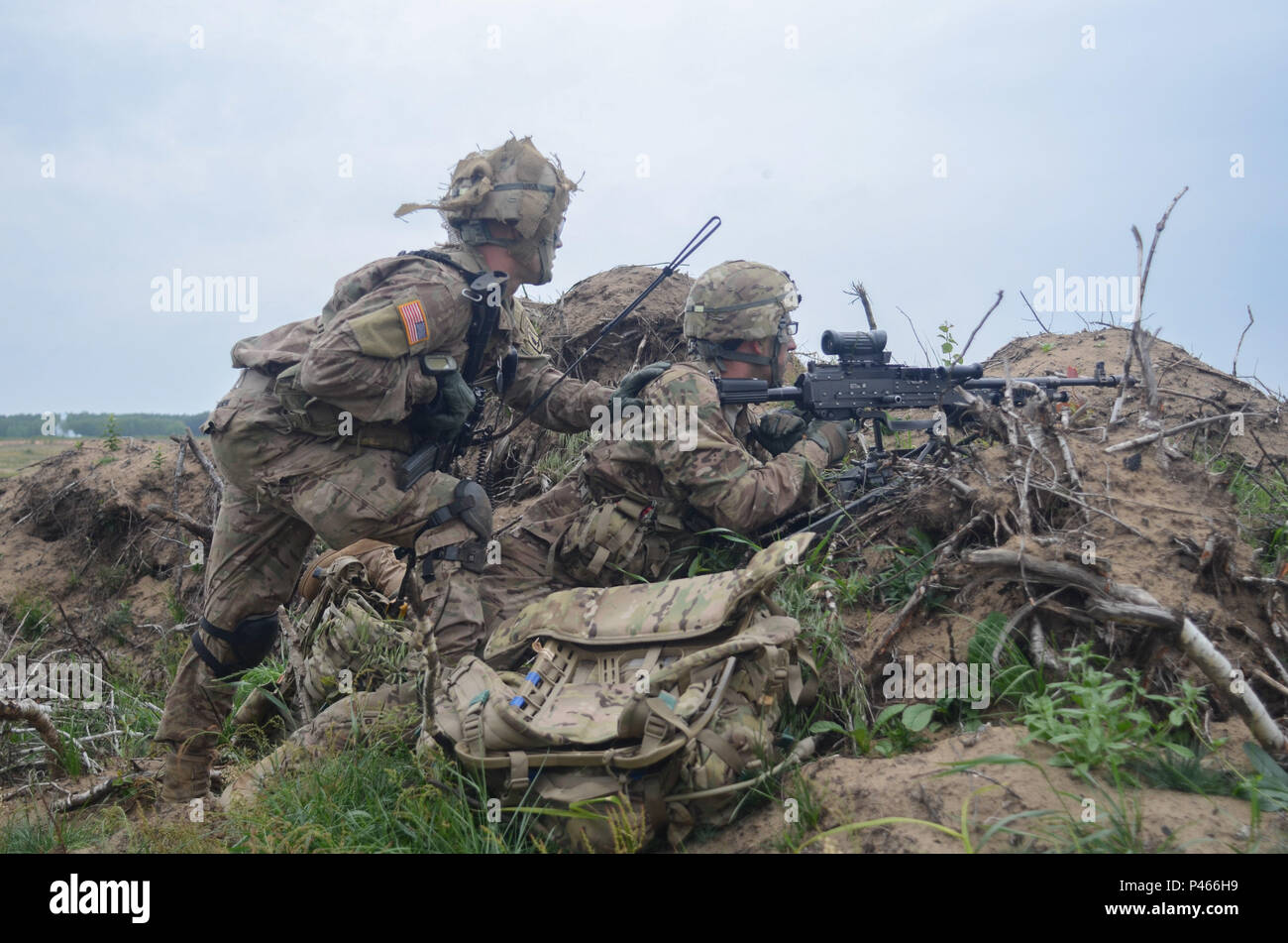 Soldiers from 3rd Platoon, 'Chosen' Company, 2nd Battalion, 503rd Airborne Infantry Regiment providing cover fire during an assault operation during Exercise Saber Strike 16. Saber Strike is a long-standing U.S. Army Europe-led cooperative training exercise designed to prepare the 13 participating nations to support multinational contingency operations. The exercise - taking place from May 27-June 22 in multiple locations throughout Estonia, Latvia and Lithuania - serves as an effective proving ground for units to validate their ability to assemble rapid-reaction forces and deploy them on shor Stock Photo