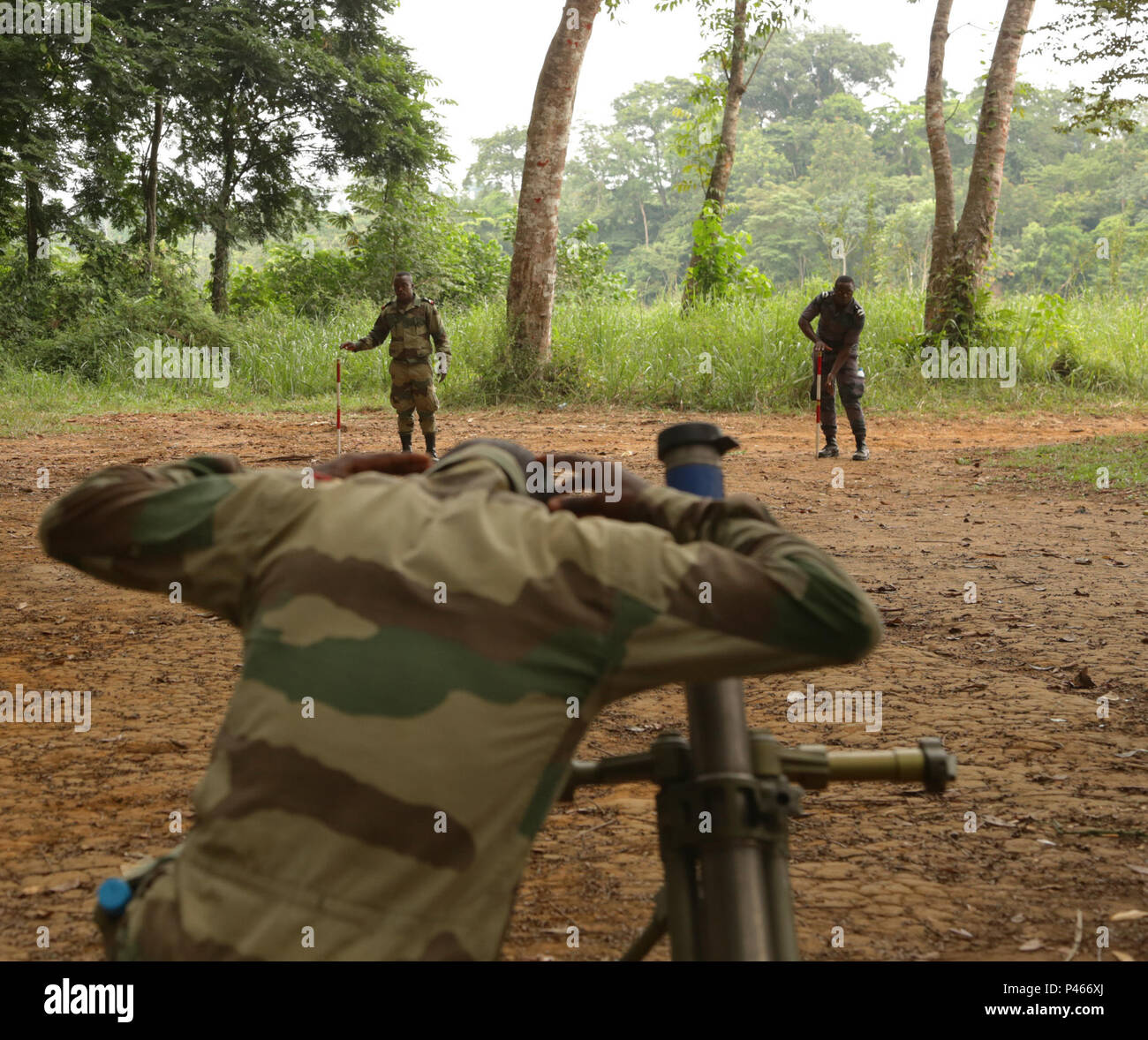 Gabonese service members line the sights of an M224 60 mm mortar system ...