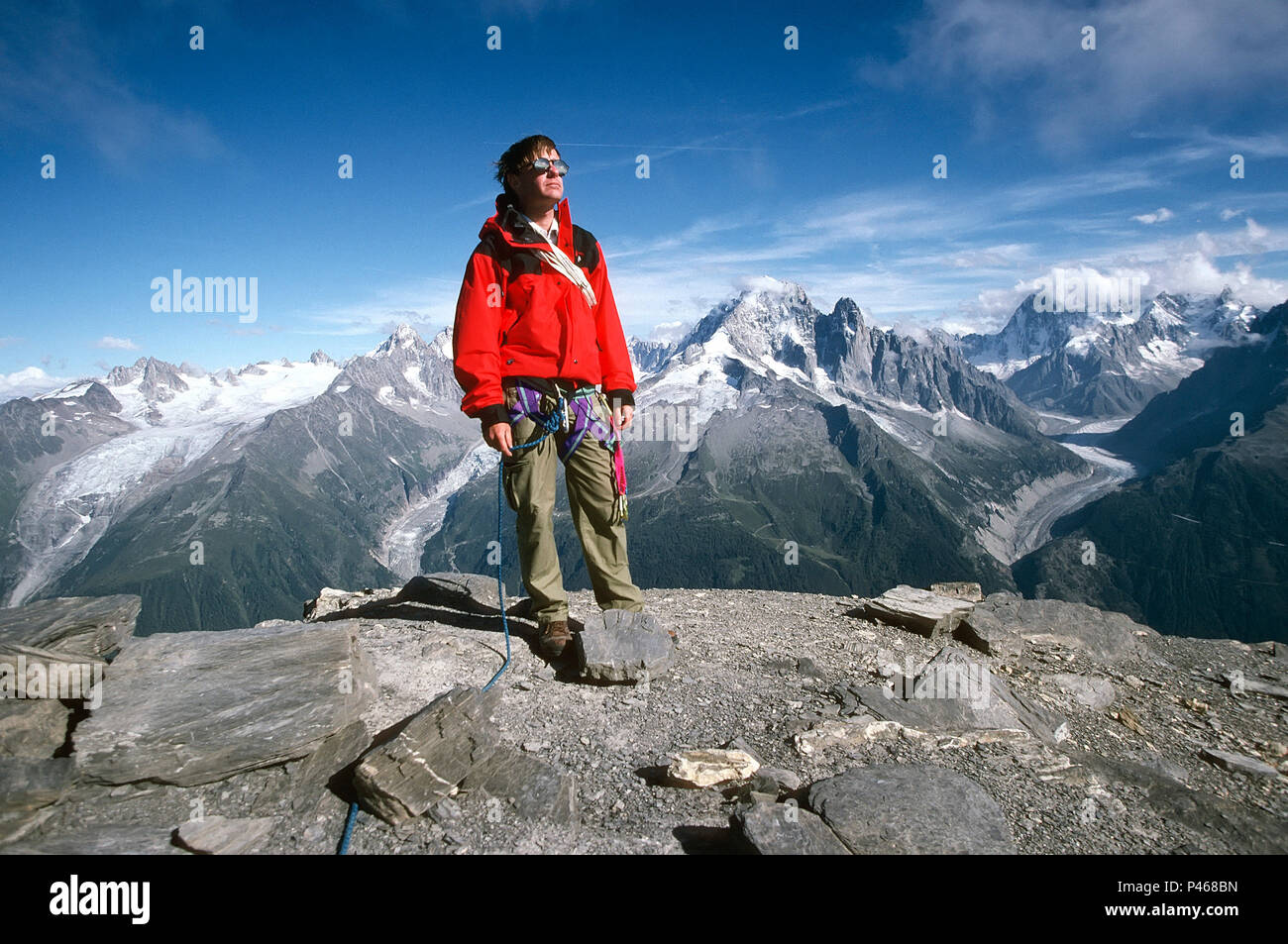 A climber poses on the summit of Aiguille de la Belvedere in the Chamonix Alps, France Stock Photo