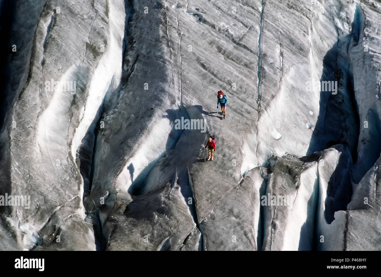 Climbers and their shadows on the glacier Trelatete and crevasse in the French Alps Stock Photo
