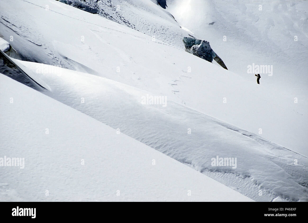 A tiny figure among big crevasses in the French Alps Stock Photo