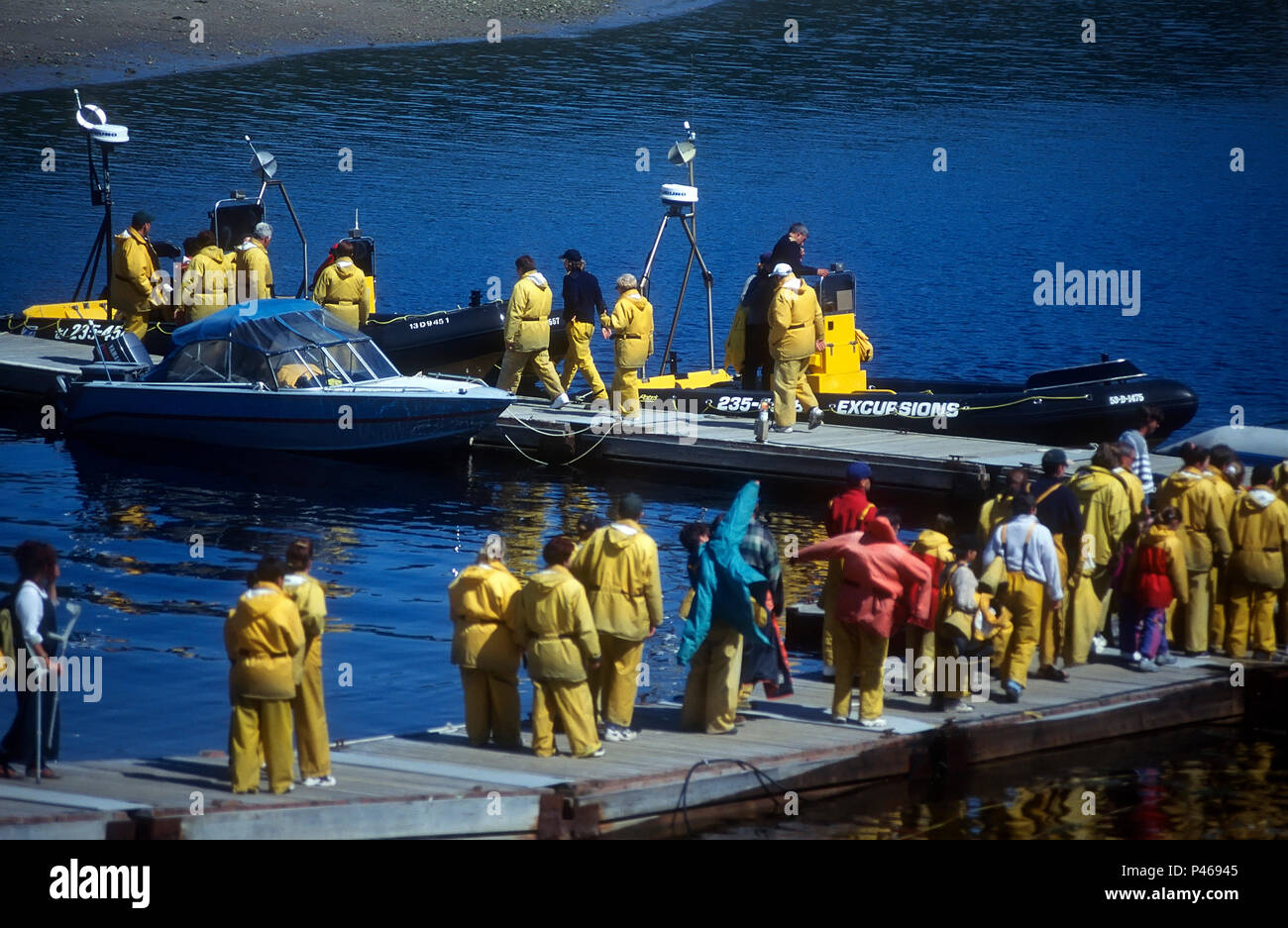 People queueing to get in their zodiac for a whale watching trip at Tadoussac, Quebec Stock Photo