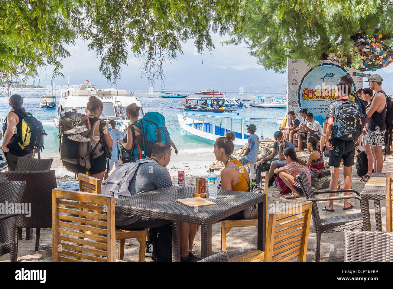 Backpackers sitting in a restaurant, waiting for the ferry to Lombok and Bali, Gili Trawngan, Indonesia, April 26, 2018 Stock Photo