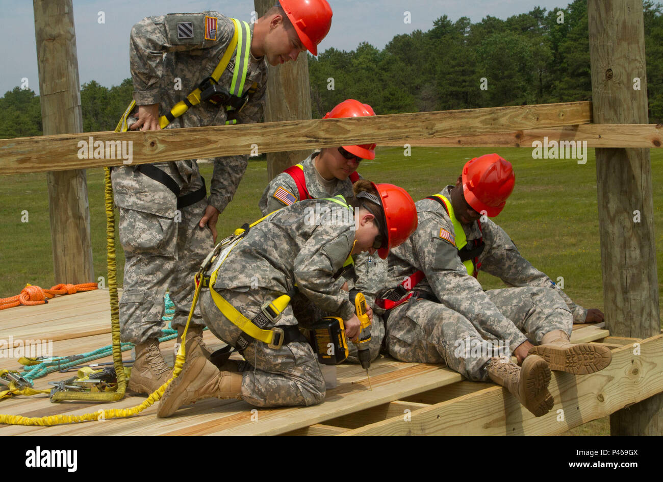 Soldiers from the 412th Engineer Company, U.S. Army Reserve, build an ...