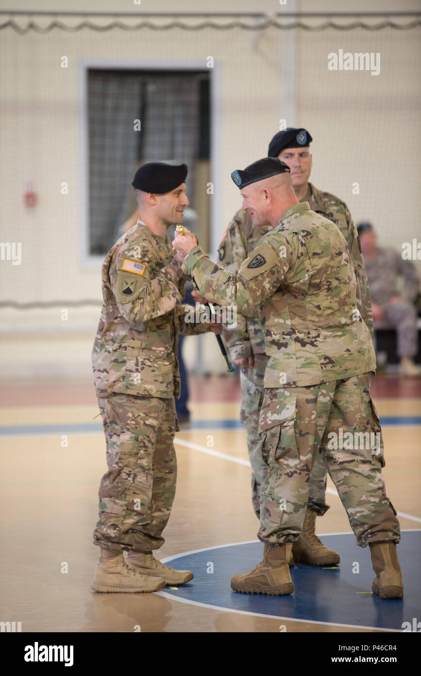 U.S. Army Command Sgt. Maj. Travis R. Childers, right, relinquishes responsibility of Allied Forces North Battalion by handing the noncommissioned officer sword to to Lt. Col. Michael Minaudo, AFNORTH Bn commander, in Chièvres, Belgium, June 30, 2016. (U.S. Army photo by Visual Information Specialist Pierre-Etienne Courtejoie/Released) Stock Photo