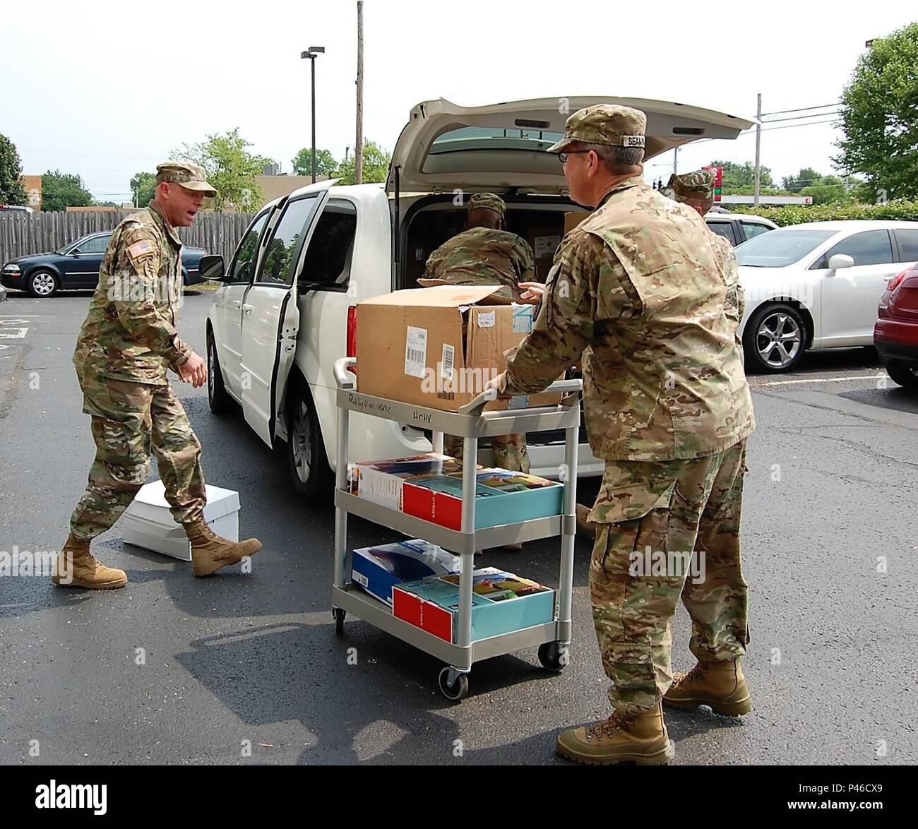 Human Resources Command leaders deliver a van full of donated clothing and household items to 