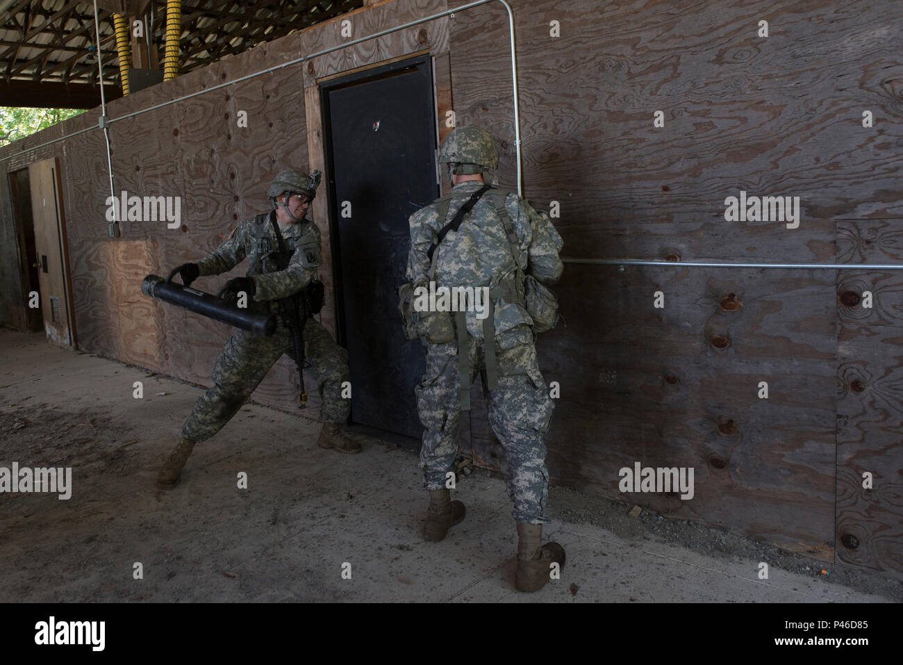 U.S. Army Spc. John Nicastro (left) and Spc. Forrest Watkins, both assigned to Alpha Company, 3rd Battalion, 172nd Infantry Regiment, 86th Infantry Brigade Combat Team (Mountain), Vermont National Guard, prepares to breach a door at Camp Ethan Allen Training Site, Jericho, Vt., June 15, 2016. The Soldiers are running through an assault lane as part of a buddy-team exercise, during their two-week annual training. (U.S. Air National Guard photo by Tech. Sgt. Sarah Mattison/Released) Stock Photo