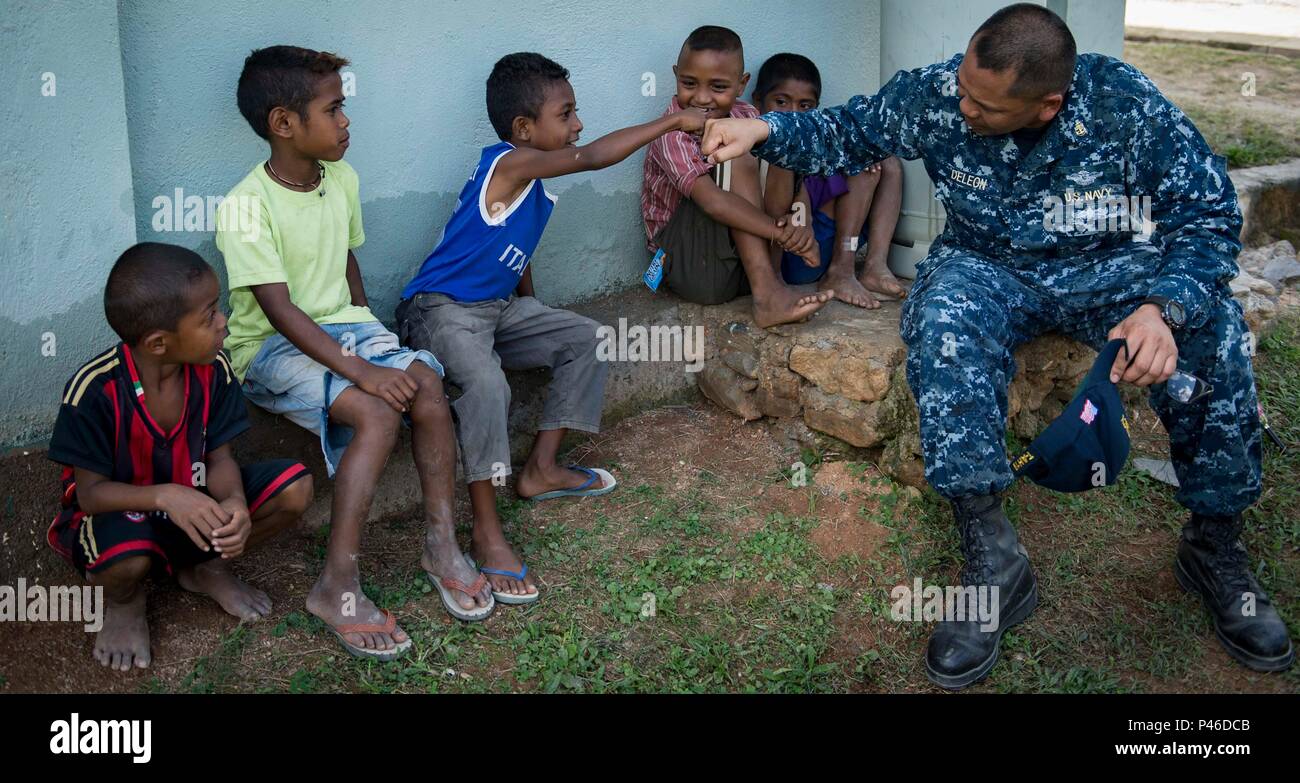 160613-N-QW941-727 DILI, Timor Leste (June 13, 2016) Chief Hospital Corpsman Larry Deleon, a native of Delano, California, assigned to USNS Mercy (T-AH 19) fist bumps a Timorese boy at Gleno Community Health Center during a Pacific Partnership 2016 cooperative health engagement. This year marks the sixth time the mission visited Timor Leste since its first visit in 2006. Medical, engineering and various other personnel embarked aboard Mercy are working side-by-side with partner nation counterparts, exchanging ideas, building best practices and relationships to ensure preparedness should disast Stock Photo