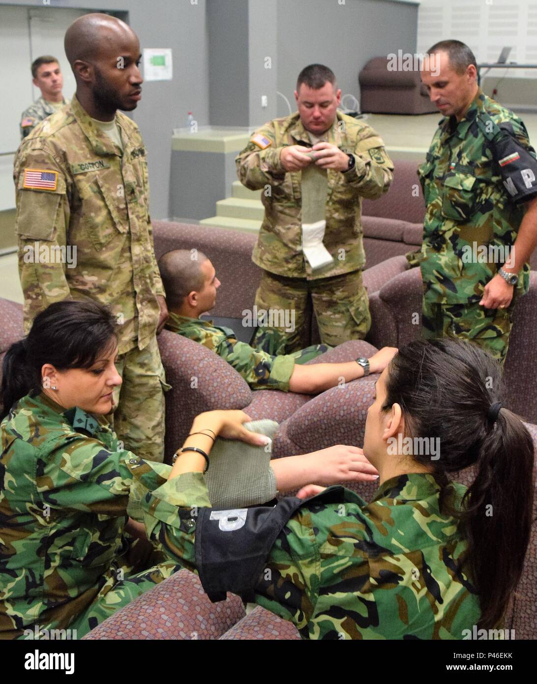 Soldiers from the Tennessee Army National Guard and from the Bulgarian  Military Police practice applying bandages to wounds during a combat  lifesaving class on June 22, 2016 during Operation Resolute Castle in