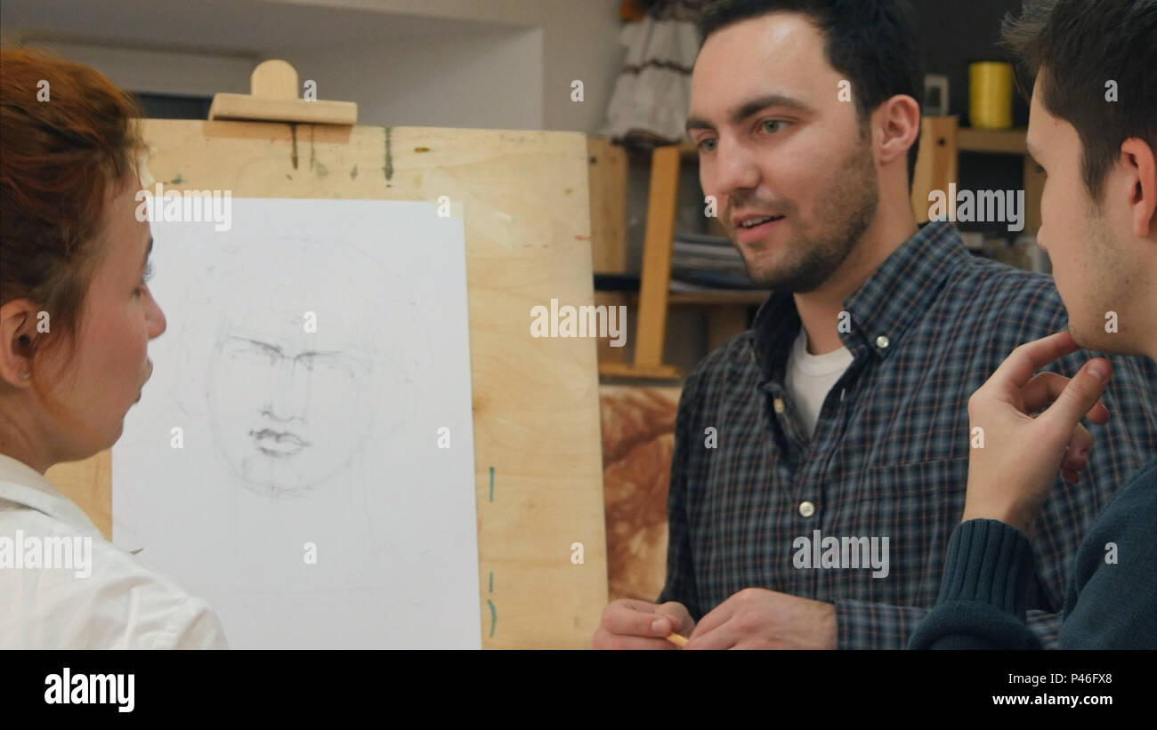 Two male students asking questions about drawing techniques Stock Photo