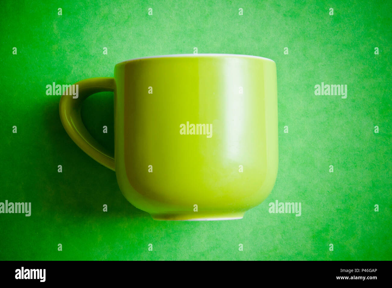green cup for coffee on a green background Stock Photo