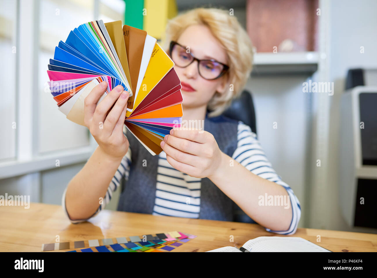 Designer looking at color samples Stock Photo