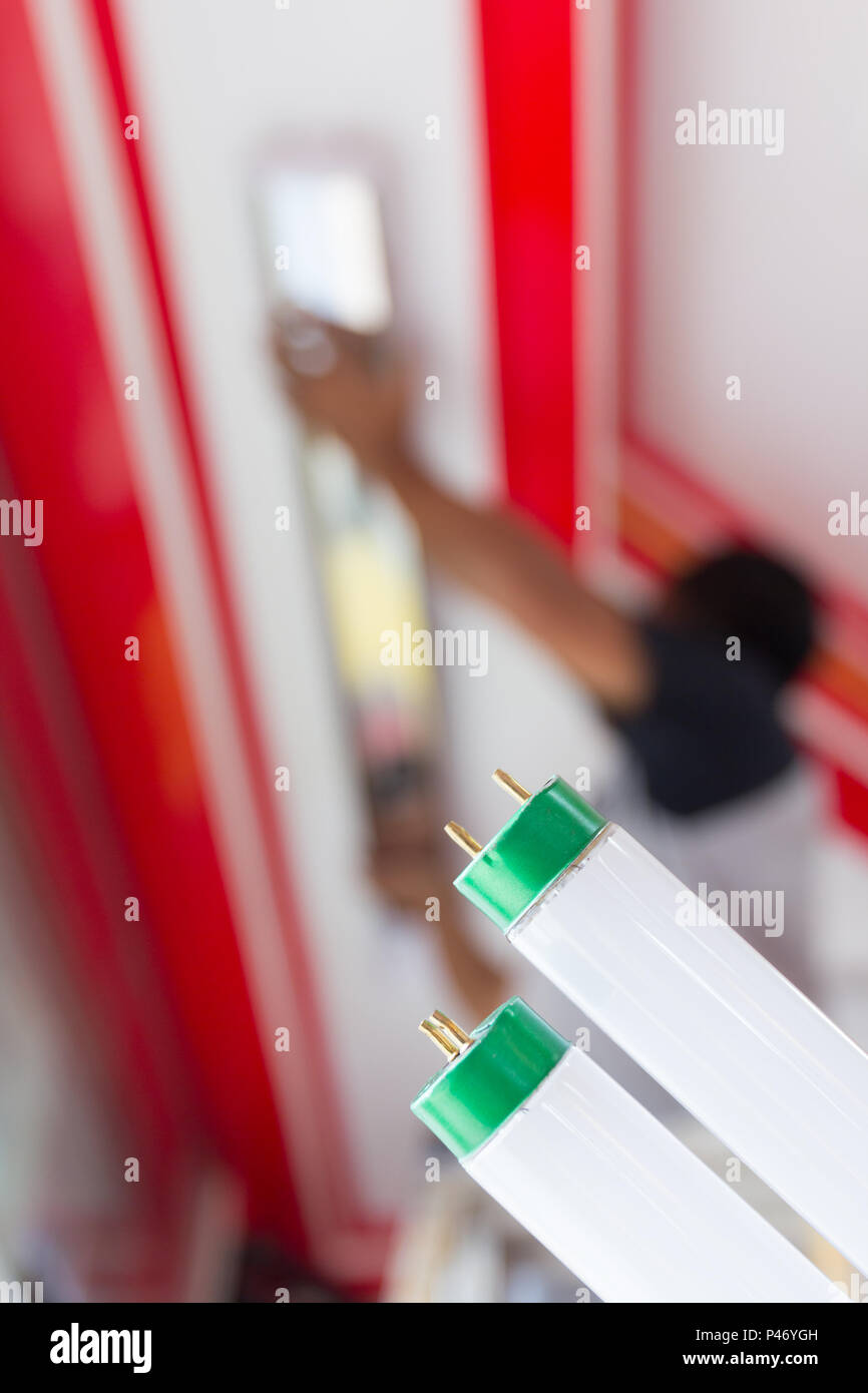 Setup fluorescent light green power on ceiling, selection focus, copy space background. Stock Photo