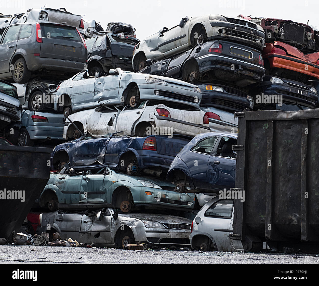 Scrapyard with car bodies piled up Stock Photo