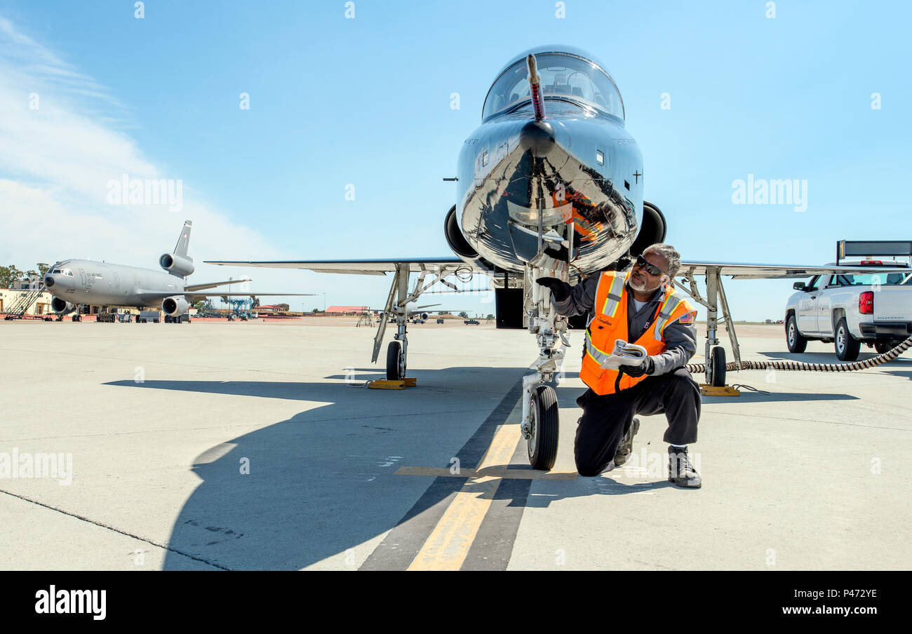 Jonathan Thorpe, assistant project manager, transient alert, 60th Maintenance Squadron, prepares a T-38 Talon from Beale AFB for fueling, June 10, 2016, Travis AFB. Unlike self-service gas station, where cars and trucks must pull up to the pump, the responsibility of refueling airplanes falls on the shoulders of the fuels management flight personnel who must pull up to the parked aircraft in vehicles carrying the fuel. (U.S. Air Force Photo by Heide Couch) Stock Photo