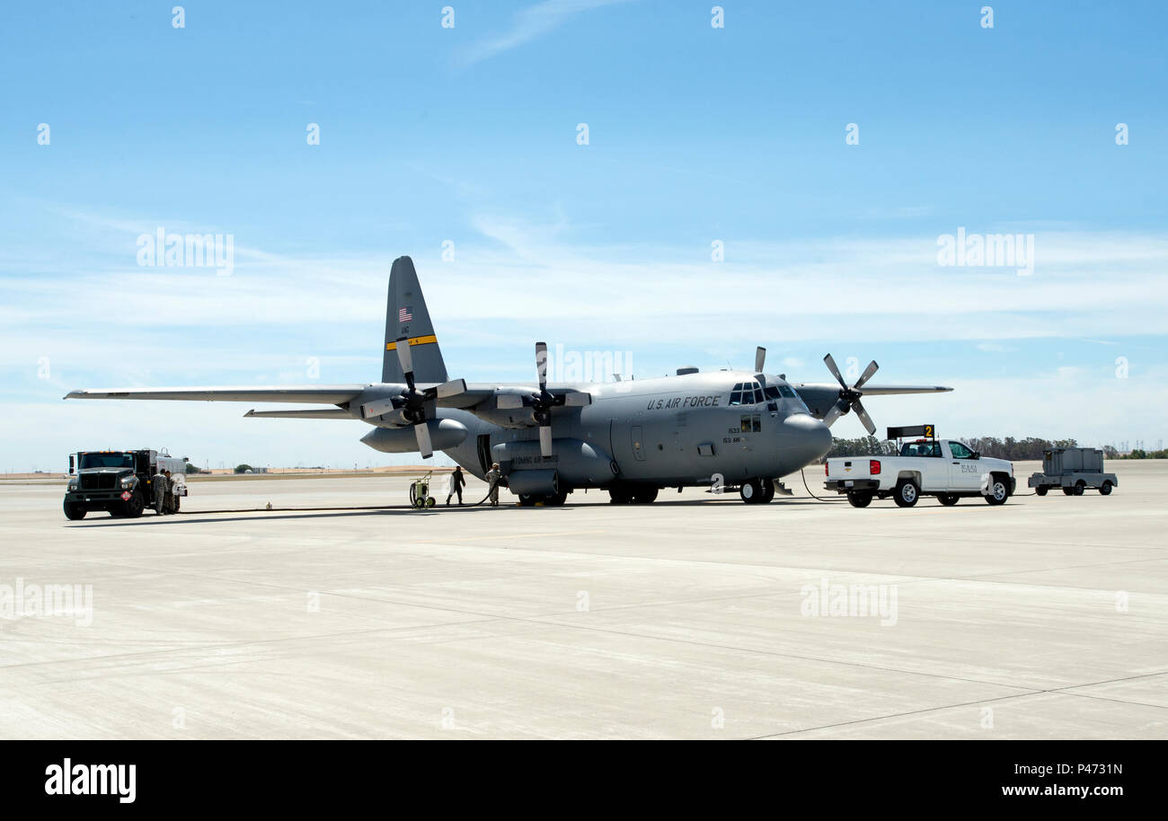 A U. S. Air Force National Guard C-130 Hercules gets refueled on the ramp at Travis AFB, Calif., June 10, 2016. The Fuels Management Flight is charged with managing the base's jet fuel, diesel fuel, unleaded gasoline, liquid oxygen and liquid nitrogen products. In order to manage these products, they are received from a local contractor into the base storage facilities. From there, they account for every gallon, from the time it enters the base, until it touches the skin of the aircraft or the vehicle tank. (U.S. Air Force Photo by Heide Couch) Stock Photo