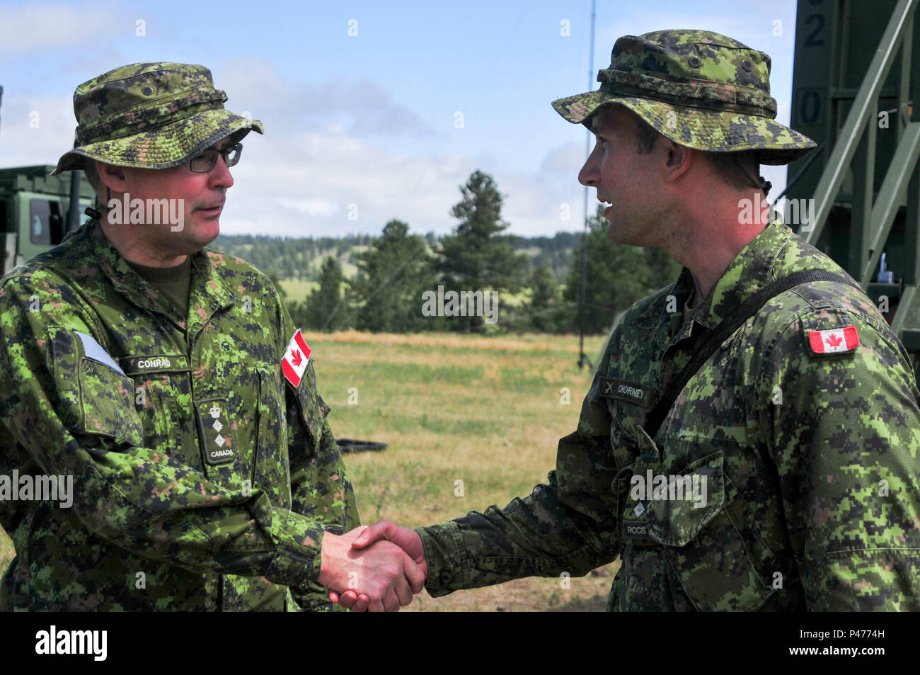 Canadian Army Col. John Conrad, commander of the 41 Canadian Brigade Group meets with Canadian Army 2nd Lt. Drew Chorney of the 41 Signals Regiment out of Calgary, Alberta as part of Golden Coyote at Forward Operating Base Custer, Custer, S.D., June 15 2016. The Golden Coyote exercise is a three-phase, scenario-driven exercise conducted in the Black Hills of South Dakota and Wyoming, which enables commanders to focus on mission essential task requirements, warrior tasks and battle drills. (U.S. Army photo by Spc. Robert West /Released) Stock Photo