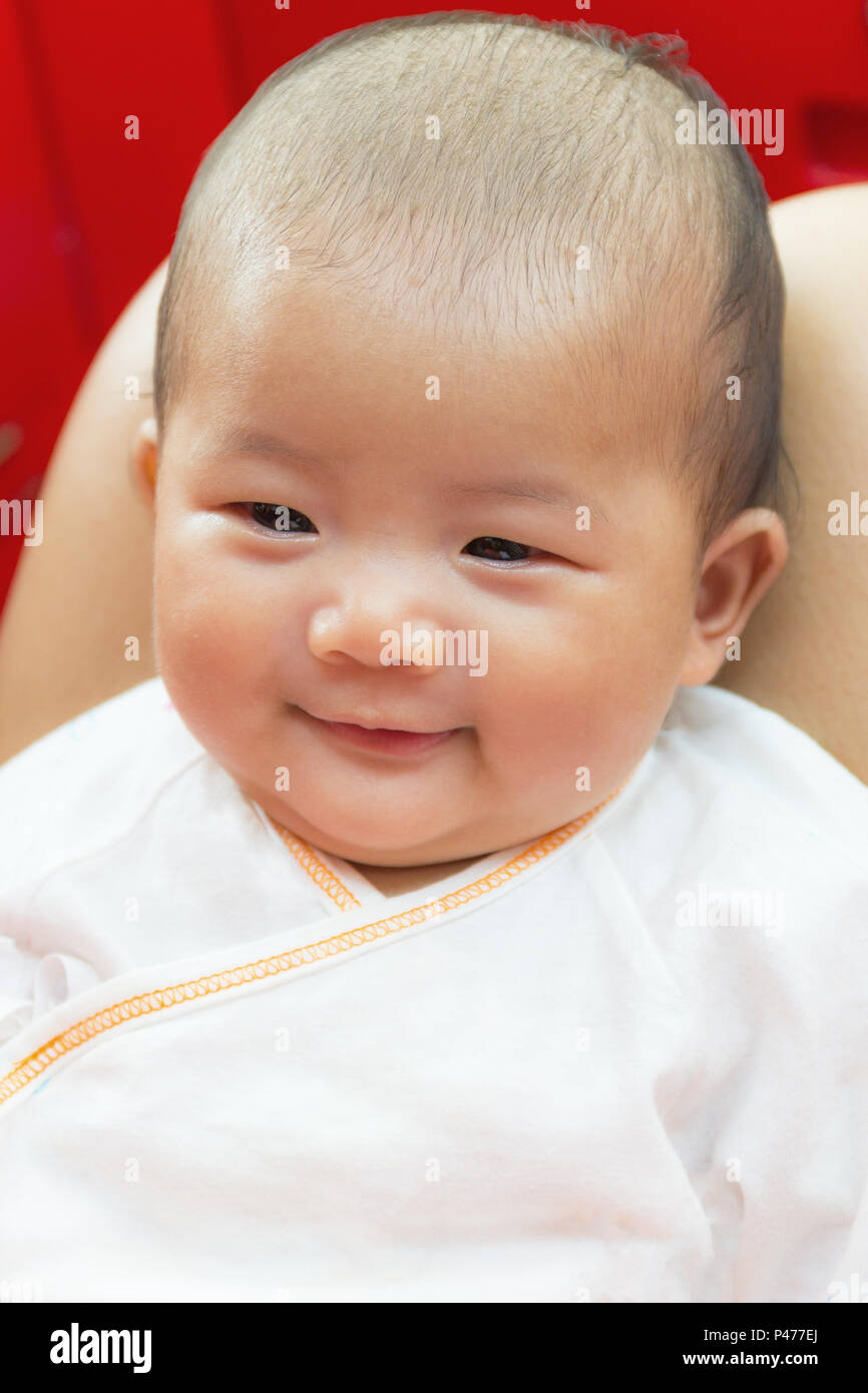 Close - Up Two month old new born asian cute baby smile rests ...